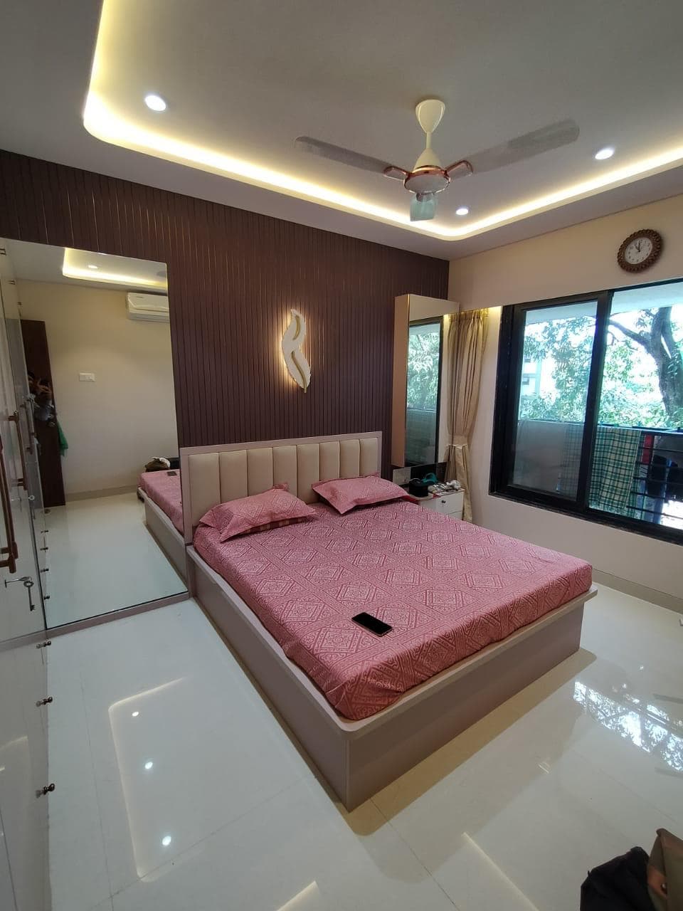 Hydraulic bed with fluted accent wall and cove lighting