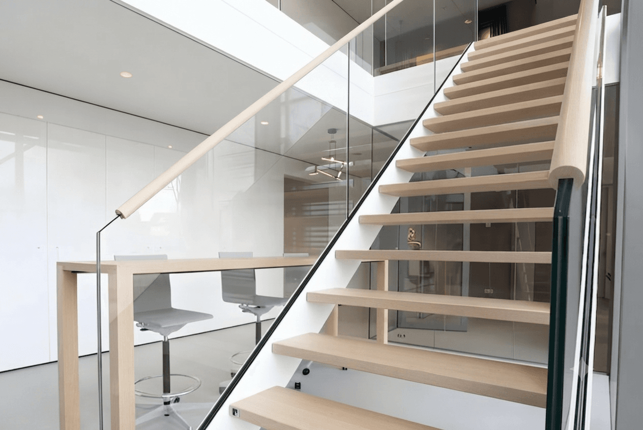 Contemporary frameless glass staircase railing with wooden steps