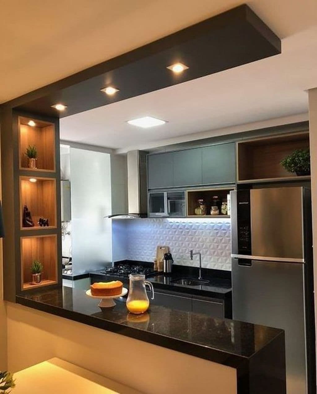 Stylish parallel modular kitchen with built-in appliances and warm lighting