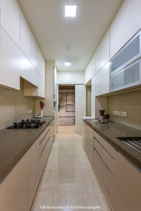 Clean white parallel kitchen layout with sleek storage compartments